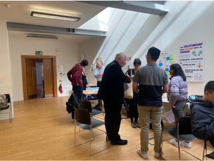 University students and staff discussing ideas.