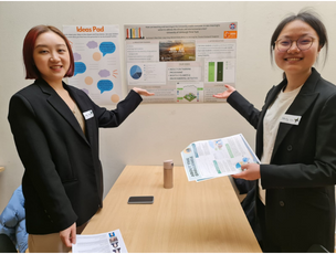 A couple of change agents in front of their posters