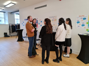 University staff and students discussing their ideas.